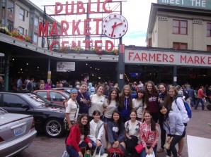 Academt girls stand in from of the famous Pike's Market in Seattle, Washington.