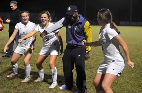 Lester, Boos, and junior Hannah Menendez teach coach, Kareem Escayg, DLOW's "Bet You Can't Do It Like Me" after winning districts.