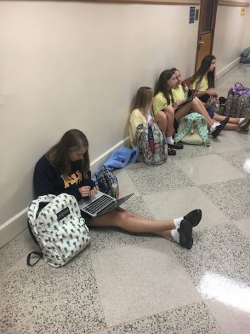 Freshmen take advantage of breaks during school to study in the hallways.