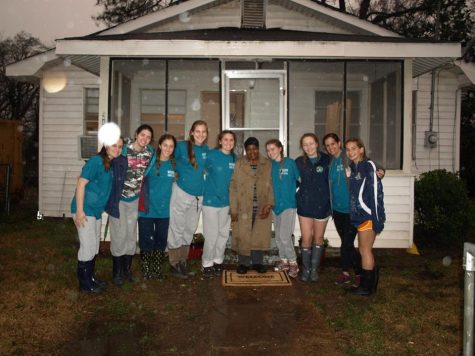 Academy missionaries smile in the rain, proud of all of their hard work. Photo Credit: Lizzie Dolan (used with permission) 