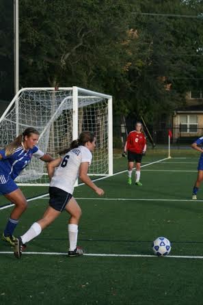 Hannah Menendez passing the ball to her teammates.