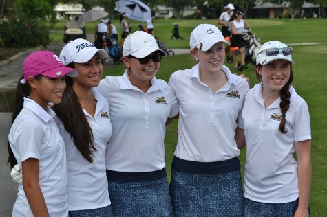 Shown are a few members of the golf team posing after a successful golf tournament.