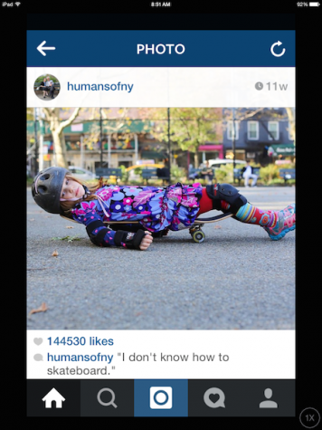 A young girl lays on a skateboard to prove she truly doesn't know how to write a skateboard.
