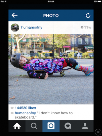 A young girl lays on a skateboard to prove she truly doesn't know how to write a skateboard. 