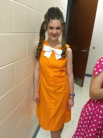 Lizzie's orange dress and white bow made her a mirror image of Penny!