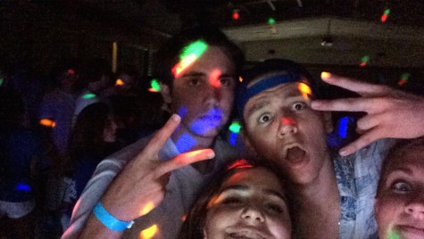 Seniors Remi Storch and Avery Dierks enjoy the music and colorful lights with some of their Jesuit brothers!