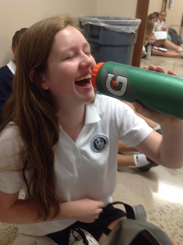 Morgan playfully pretends to drink from her gatorade bottle.