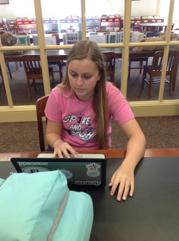 Haley Schumann diligently working on her new Macbook Pro