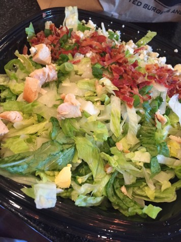 The Grilled Chicken Salad is always a great and delicious option to order at PDQ, topped with bacon pieces.