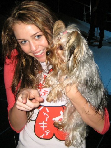 Miley Cyrus in 2007 showing her love for animals with her dog!