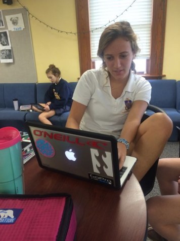 Senior, Hadley Chillura, working on her Economics homework in the lounge