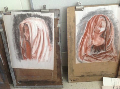Alessandra Tanase and Mollie Johnson (right) used sanguine to create these unique portraits of McKenzie.