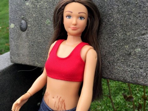 Lammily shows off her stretch marks to encourage girls to love their body no matter what shape or size.
