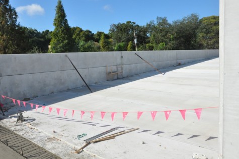 View from the top level of the future parking garage. The pink flags represent the dry part of the pavement, and the pouring/smoothing of concrete. PhotoCredit: Riley Gillis