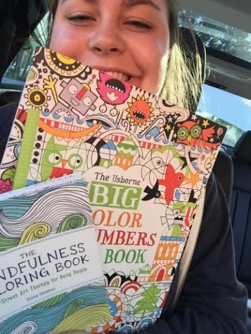 Photo Credits: Rachel McKenna Junior, Rachel McKenna smiles as she holds her newly purchased coloring books for her road trip to Georgia.