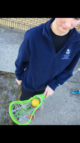 Each girl has their own lacrosse stick with their own individual nets and tape. Alexa Traviesa has a neon green stick with white and green net. 