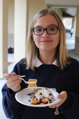 (Credit: Keri Kelly/Achona Online) Sophomore AnnMarie Collins enjoys a strawberry Nutella crepe with chocolate syrup and whipped cream from the French bake sale. The profits are going to support the Holy Names sisters' mission in Vietnam.