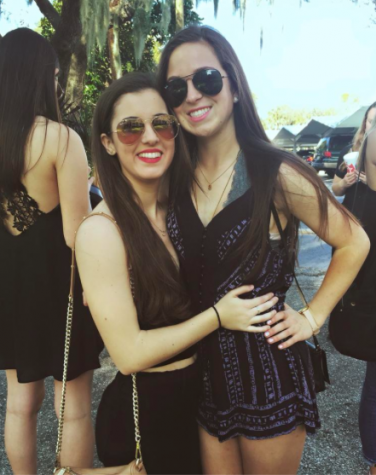 Junior classmates Bella Guerra and Ellie Abdoney gather together on Rome street during the parade