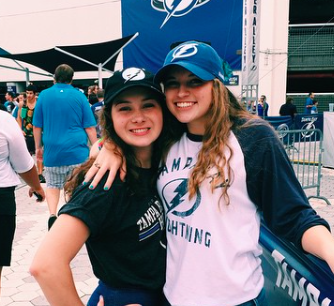 Seniors, Karlee Nipper and Jacqueline Brooker rock the hat trend at a Lightning Game!