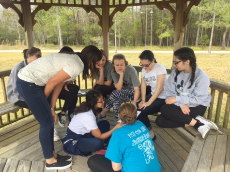 Students working in their small groups on word puzzles. Christina Thompson states, "My group worked well together. It was good to know that no matter who we get paired with, we always get along and have a good time."