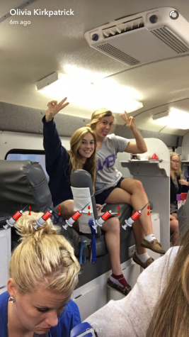 Olivia Kirkpatrick catches seniors Mary DeRoisers and Megan Bajo before they both donate.