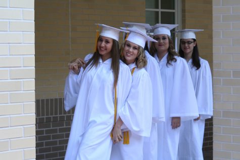 The gold tassle represents the Senior's membership in the National Honors Society. 