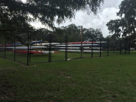 A chainlink fence and wooden racks prove to be a modest, but efficient, boathouse. Photo Credit: Audrey Anello/Achona Online