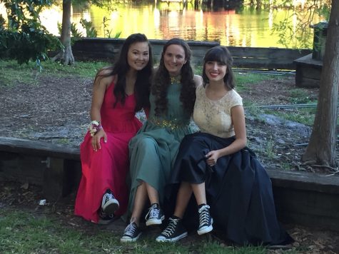 Seniors Julianne Nichter, Sarah Tevlin, and Isabella Cartaya (pictured from left to right) sit down before prom to show off their bold choice of footwear. Photo Credit: Jen Nichter (used with permission)
