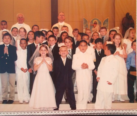 Isabella Bahr (far right) at her First Holy Communion at St. Lawrence with Monsignor Higgins (far left). Bahr spent ten years at STL. 