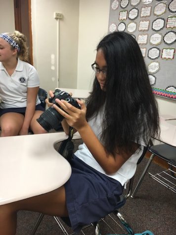 Laura prepares her camera to capture many memories at Senior Reflection day.