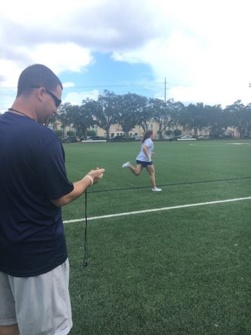 Chris Severini checks the time as his player finishes a lap.