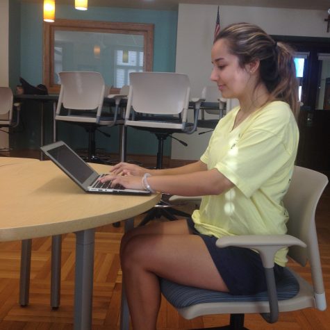 Junior, Françoise Corser, exhibits the proper posture while using her MacBook. Photo Credit: Sara Phillips/AchonaOnline