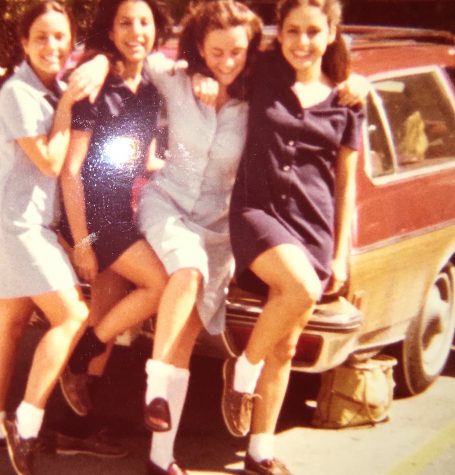 Smith and three friends pose in front of a car in the senior parking lot.