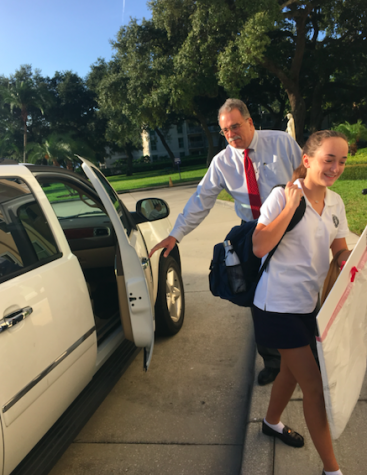 Raimo greets Madelyn Galleger as she arrives on a late-start Wednesday. Credit: Audrey Diaz/ Achona Online