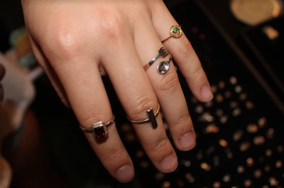 Tess Jakubiec models some of the jewelry on display at the market.