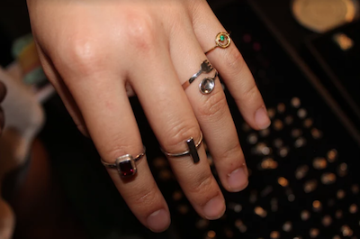 Tess Jakubiec models some of the jewelry on display at the market. 