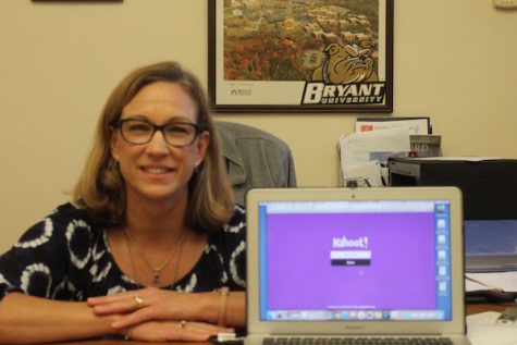 Photo Credit: Julia Prince (Achona Online) Collins similes next to her computer showing off her favorite website. She loves using kahoot to engage students.