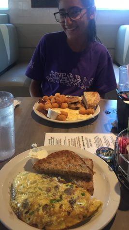 Audrey Anello smiles as Jessica Zachary snapchats a picture of Anello and her omelet. Photo Credits: Jessica Zachary (used with permission)