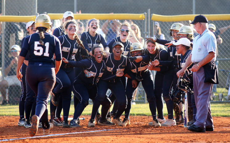 The+team+waits+at+the+plate+celebrating+Miniet%27s+homerun.+Photo+Credit%3A+Alexis+Miniet+%28used+with+permission%29.